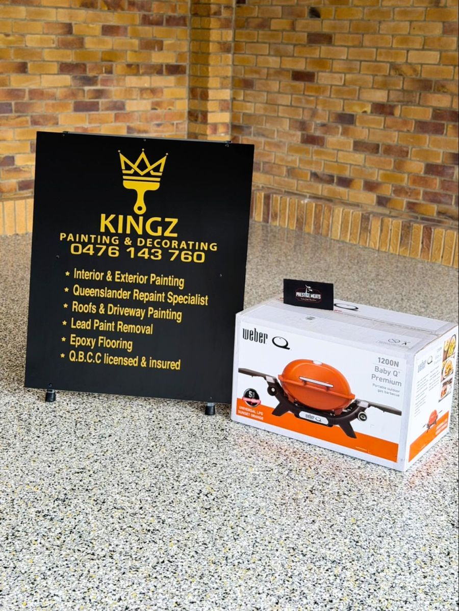 Kingz Painting and Decorating site board on a freshly coated epoxy floor.